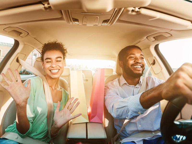 Nissan of Canton in Canton MI college grads sitting in a new car