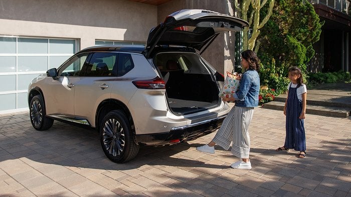 Nissan of Canton in Canton MI woman unloading her Nissan Rogue