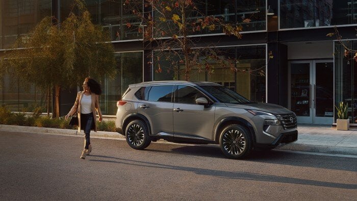 Nissan of Canton in Canton MI lady walking away from her Nissan Rogue